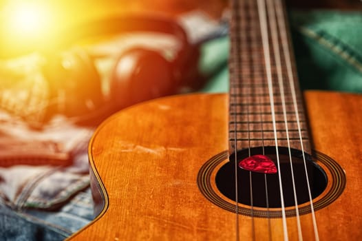 Closeup guitar pick on an old classical guitar. A guitar pick is a plectrum used for guitars.