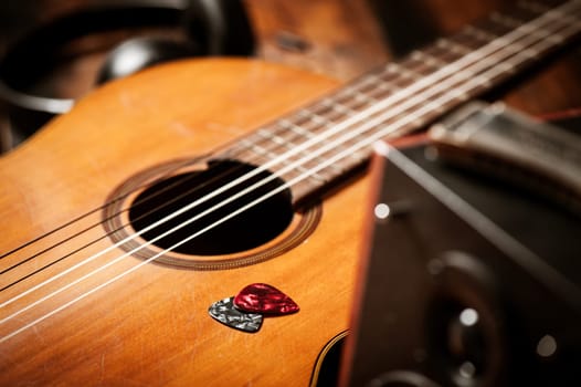 Closeup guitar pick on an old classical guitar. A guitar pick is a plectrum used for guitars.