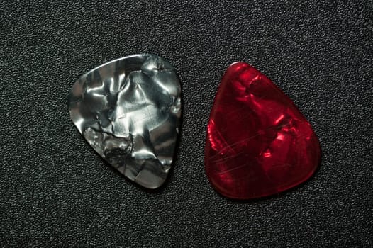 Closeup guitar pick on black background. A guitar pick is a plectrum used for guitars.