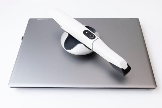 Isolated 3d Intraoral Dental Tooth Scanner and Laptop on White Background. Dental Equipment, Device For Scanning Teeth. Dentistry And Health Care Concept . Horizontal Flat Lay View, High quality photo