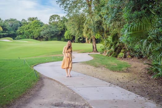 happy pregnant woman walking in the park.