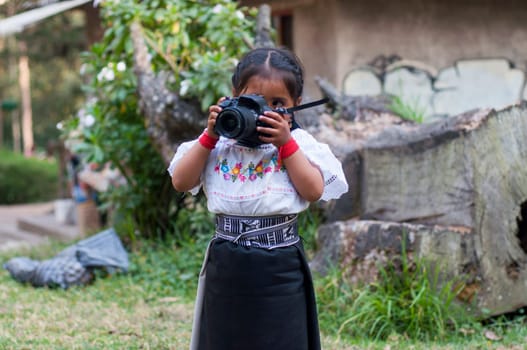 Cultural Discovery through a Child's Lens: Exploring Indigenous Attire and Reflex Camera in the Heart of the Amazon Rainforest. High quality photo