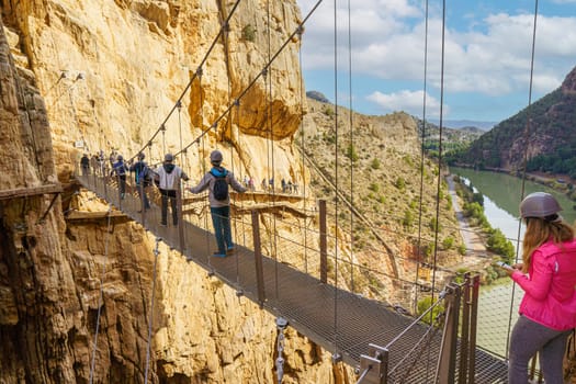 Photo of people crossing the suspension bridge of the Caminito del Rey