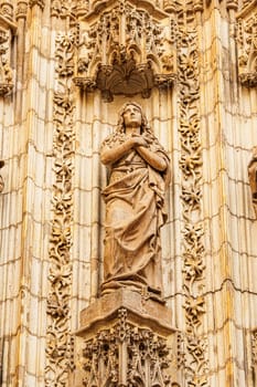 Statue of Mary Magdalene on the Assumption Gate of the Cathedral of Seville