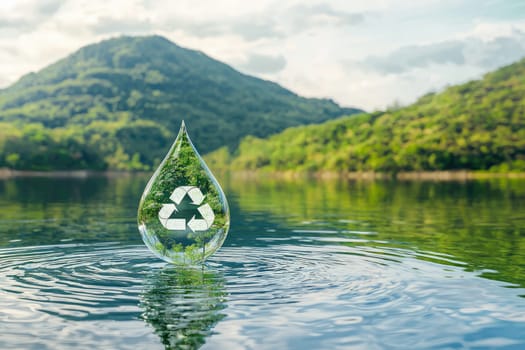A clear water droplet featuring a recycling symbol floats above a serene lake, capturing a lush green landscape, highlighting the essence of sustainability and environmental awareness.