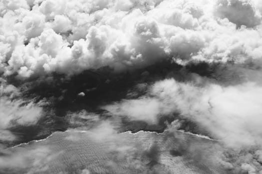 Cloudy coast. Aerial view of a beautiful ocean coastline in black and white