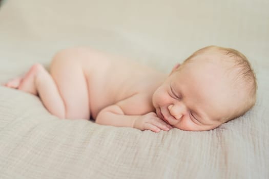 The baby is sleeping peacefully in his cozy nest. Newborn photo session captures the serene innocence and warmth of early moments.