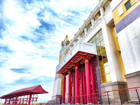 The Golden Buddha Temple in Elista features vibrant colors and stunning architecture under a clear blue sky, inviting tranquility and reflection.
