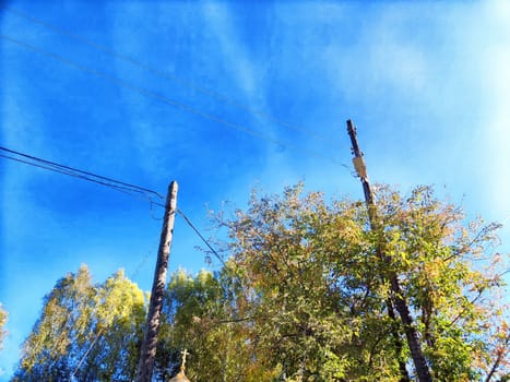 Old pole with wires against the sky. Electric transmission line, Eco-friendly energy