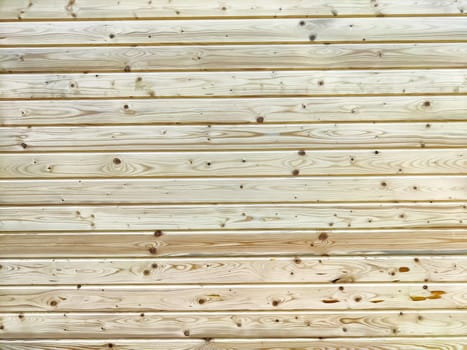 A light, textured wooden surface displaying natural grain patterns, ideal for creative projects needing background space for text or graphics.