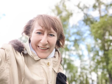 A woman, adorned in a stylish fur hooded jacket and donning a protective mask, is smiling brightly despite the circumstances