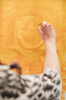 Woman painted a smiley face with paints