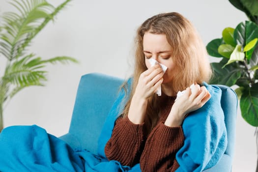 Sick, influenza young woman, girl headache have fever, hand touching forehead, holding thermometer for check measure body temperature, illness while sitting rest on sofa at home. Health care