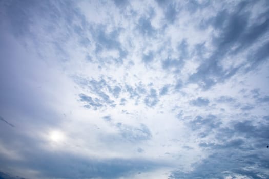 A stunning view of a cloud-filled sky, showcasing dynamic patterns and soft sunlight in the background.