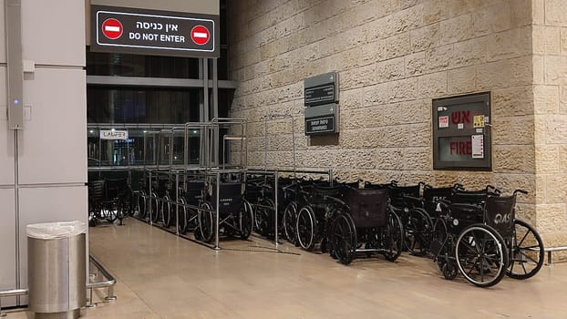 15 October 2024 Tel-Aviv Israel Ben Gurion airport Terminal 3, black wheelchairs for people with disabilities, tourist lounge. High quality photo