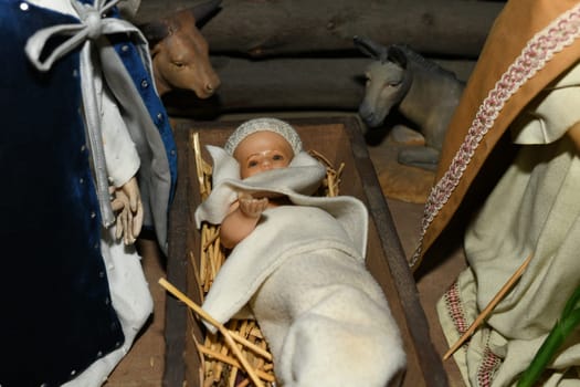 Baby Jesus laying in a cradle Christmas Creche