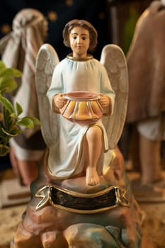 Angel with wings holds a pot in his hands Scene of the birth of Jesus Christ