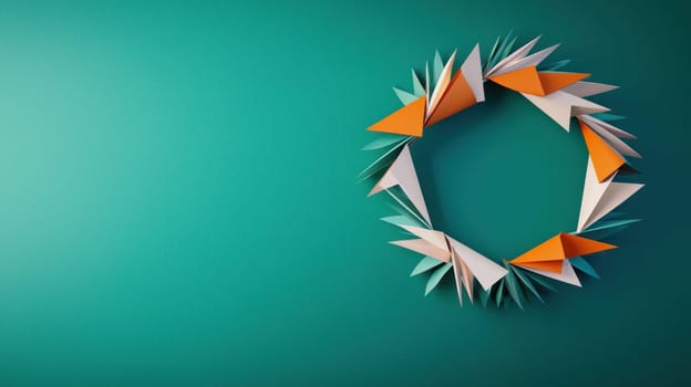 Geometric wreath made from colorful paper shapes on teal background.