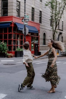 A couple is joyfully dancing on the bustling street, showcasing their love and deep connection in a vibrant city