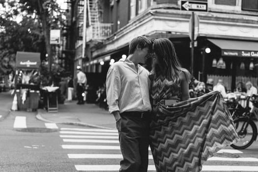A couple lovingly shares a tender embrace in front of lush vibrant greenery, capturing intimate moments of deep love