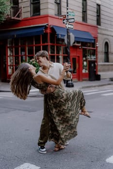 A couple is joyfully dancing on the bustling street, showcasing their love and deep connection in a vibrant city