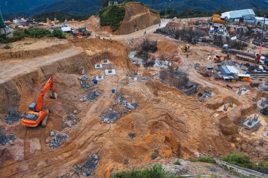 Construction site with excavators and other heavy construction equipment in the pit