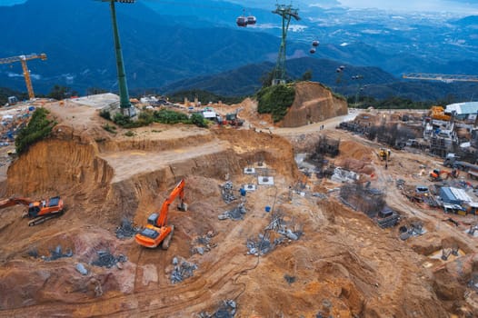 A construction site with excavators and other heavy construction equipment. Quarry with foundation preparation