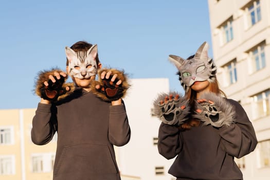Girl and boy quadrober in cat mask sit in city, quadrober children, subculture