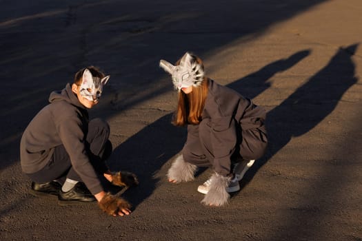 Girl and boy quadrober in cat mask sit in city, quadrober children, subculture