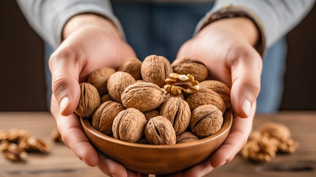 A person is carefully holding a beautifully crafted bowl filled with nutritious walnuts in their hands, emphasizing their natural goodness