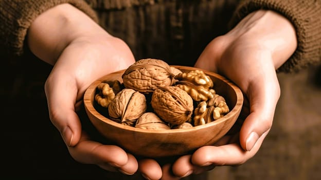 A person is carefully holding a beautifully crafted bowl filled with nutritious walnuts in their hands, emphasizing their natural goodness