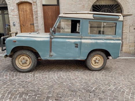 Cremona, Lombardy, Italy October 15th 2024 Classic land rover series iia parked on a cobblestone street, showcasing its timeless design and rugged appeal