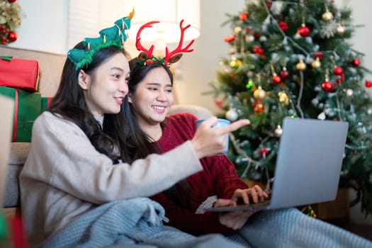 An LGBTQ couple participates in online holiday festivities using digital devices, portraying the concept of connection and celebration, underscored by technological innovation.