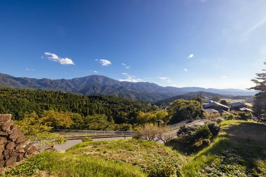 Hiking path landscape on the famous Magome-Tsumago Trail as part of the Nakasendo Way between Magome and Tsumago in Gifu Prefecture, Japan