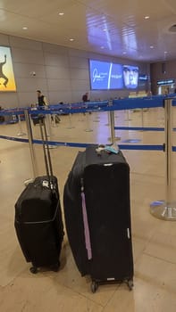 15 October 2024 Tel-Aviv Israel Ben Gurion airport, Terminal 3.Two tourists' suitcases Airport luggage are standing in the travel hall. High quality photo