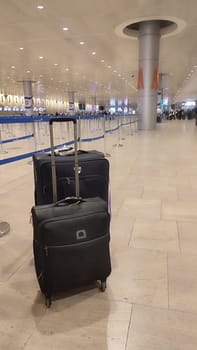 15 October 2024 Tel-Aviv Israel Ben Gurion airport, Terminal 3.Two tourists' suitcases Airport luggage are standing in the travel hall. High quality photo