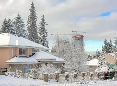Residential house in snow. Front yard of family house on a cold winter day