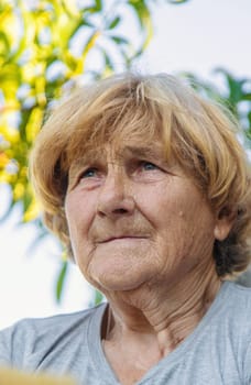 Portrait of an elderly woman in a garden. Selective focus. old.