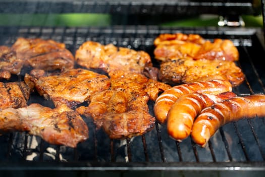 Grilled chicken and sausages on the barbecue, perfect for summer gatherings with friends and family