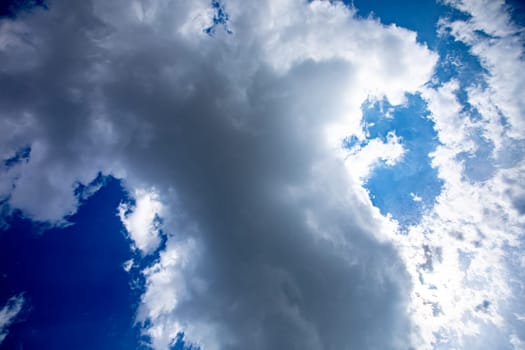 A captivating and breathtaking view showcasing the dynamic clouds animated under a vibrant, brilliant blue sky