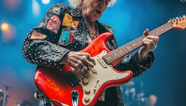 Senior female guitarist performing live on stage with red electric guitar
