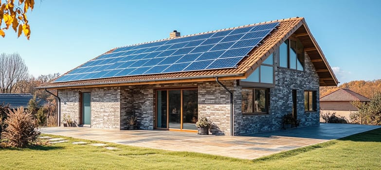 Photovoltaic panels installed on the roof of a modern brick house, providing sustainable and renewable energy