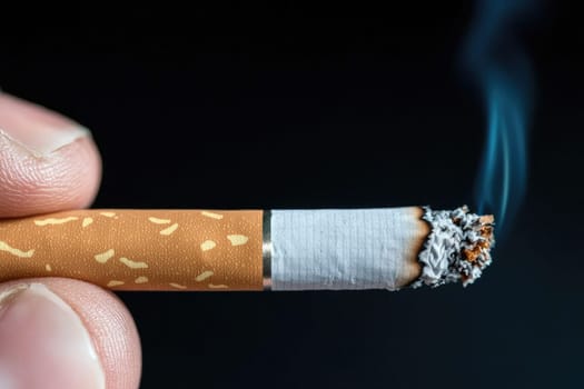 A detailed close-up image of a hand holding a glowing cigarette, featuring rising smoke and falling ash, capturing the essence of tobacco addiction and health concerns.
