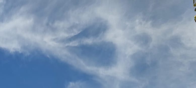 blue sky white clouds stripes, light air atmosphere nature background, weather, heart shape or angel. High quality photo