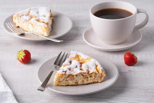 Two delicious pieces of cottage cheese casserole on a light wooden table..