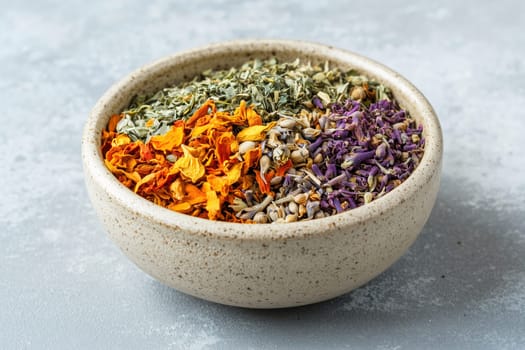The speckled bowl holds a vibrant mix of dried spices and herbs, showcasing shades of orange, green, and purple, ideal for culinary use or decoration.