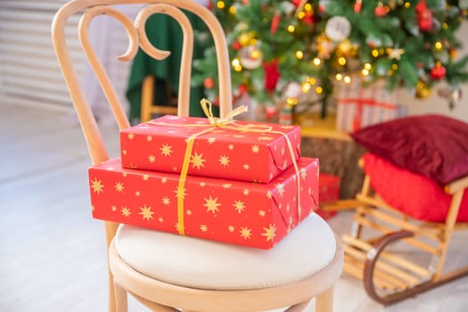 christmas tree with gift boxes.Warm living room decorated with Christmas accessories.