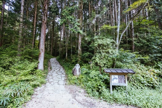 Hiking path landscape on the famous Magome-Tsumago Trail as part of the Nakasendo Way between Magome and Tsumago in Gifu Prefecture, Japan