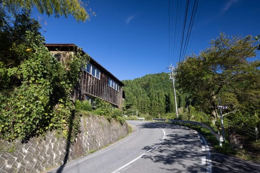 Hiking path landscape on the famous Magome-Tsumago Trail as part of the Nakasendo Way between Magome and Tsumago in Gifu Prefecture, Japan