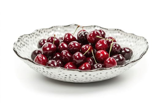 A decorative bowl filled with ripe, glossy cherries sits invitingly, reflecting light and highlighting their deep red and purple hues. Perfect for summer treats or recipes.